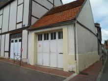 Restauration des pans de bois masqué par un enduit. Peinture  légèrement orangée et remplissage en enduit à la chaux couleur ocre. (Avant)