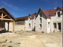 Restauration complète d'une longère : couverture et création de lucarnes, démolition, ouvertures intérieures et extérieures, ravalement, menuiseries, mur de clôture avec les pierres issues de la démolition et plancher béton à l'étage. (Après)